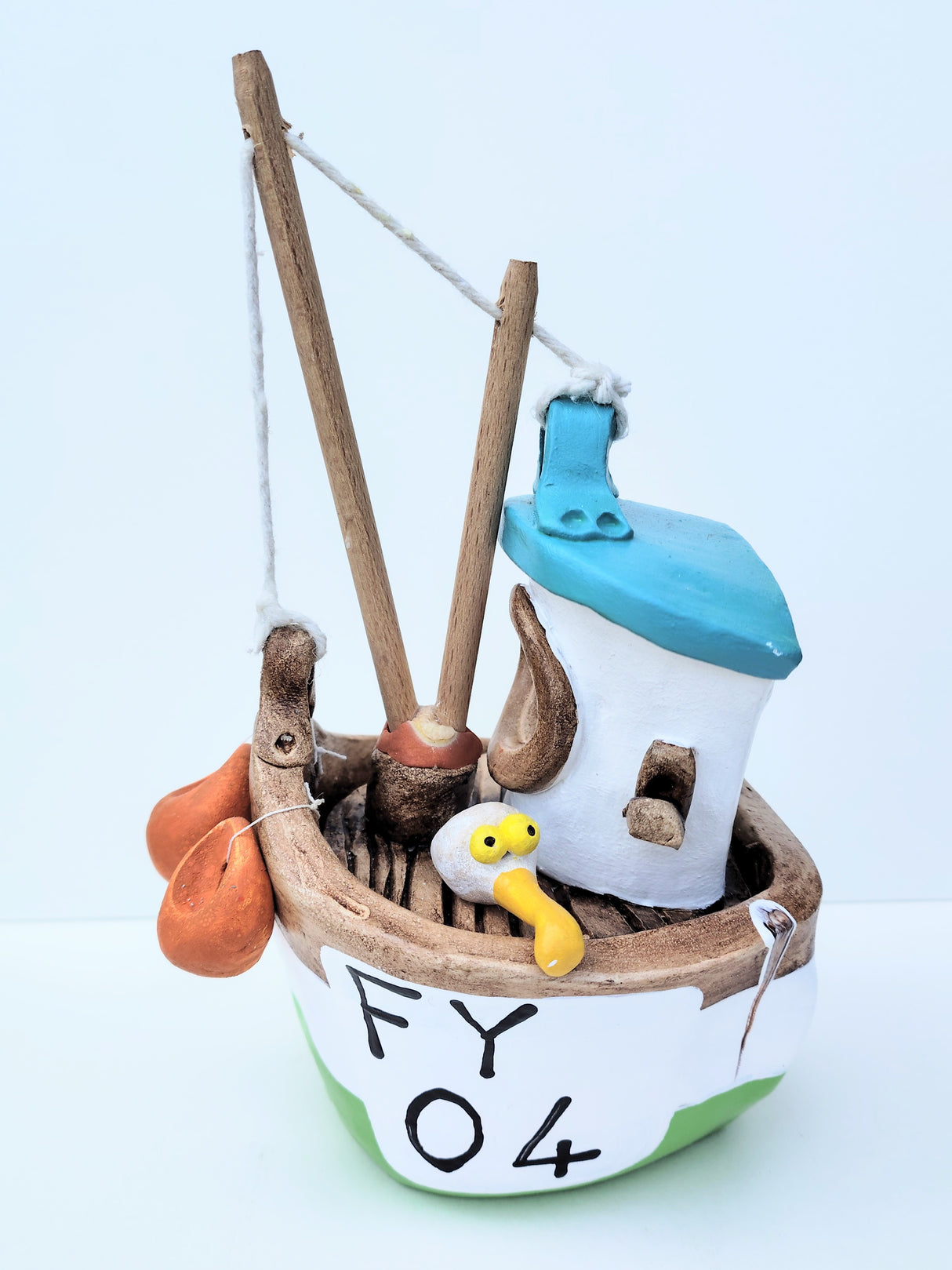 FY04 small green ceramic fishing boat by Louise Thorn