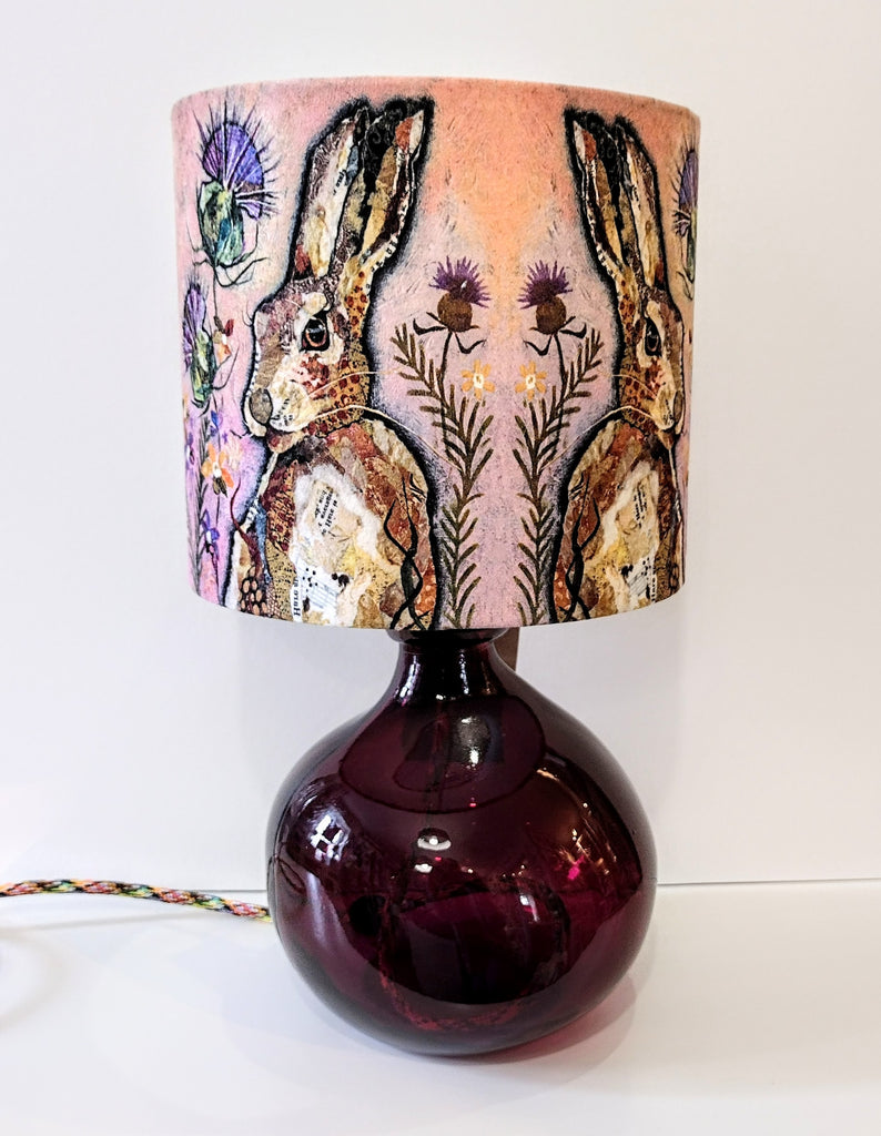 mulberry brown recycled glass lamp-base shown with a pale pink hares lampshade