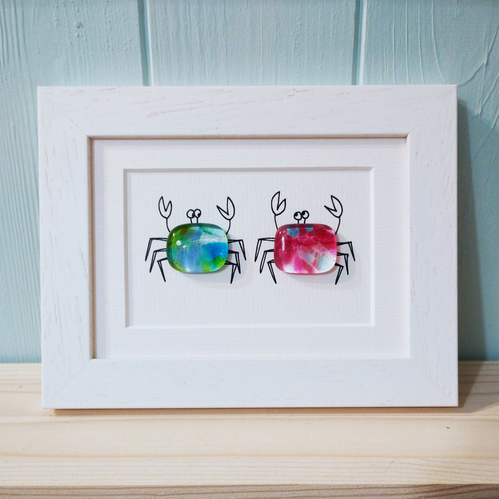 two little fused glass crabs in a white frame by Niko Brown