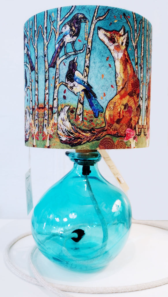 Aqua glass lamp-base shown with a fox and magpies lampshade