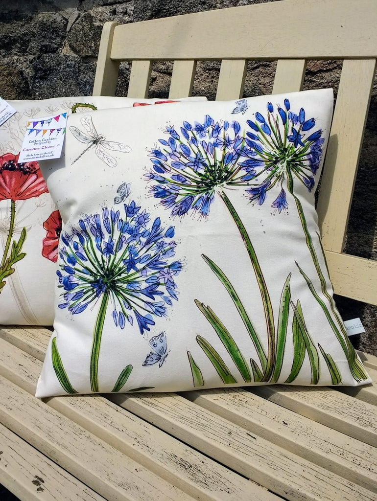 Blue agapanthus flowers on cream background cotton cushion