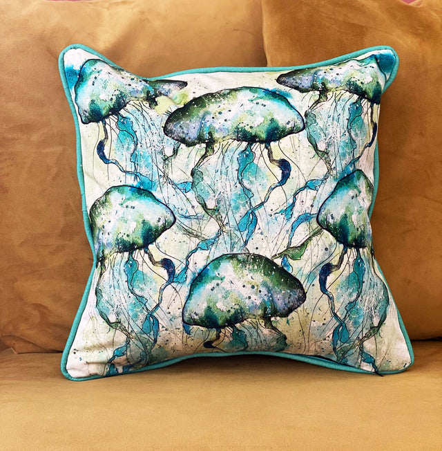 Blue and green jellyfish on cream background cotton cushion
