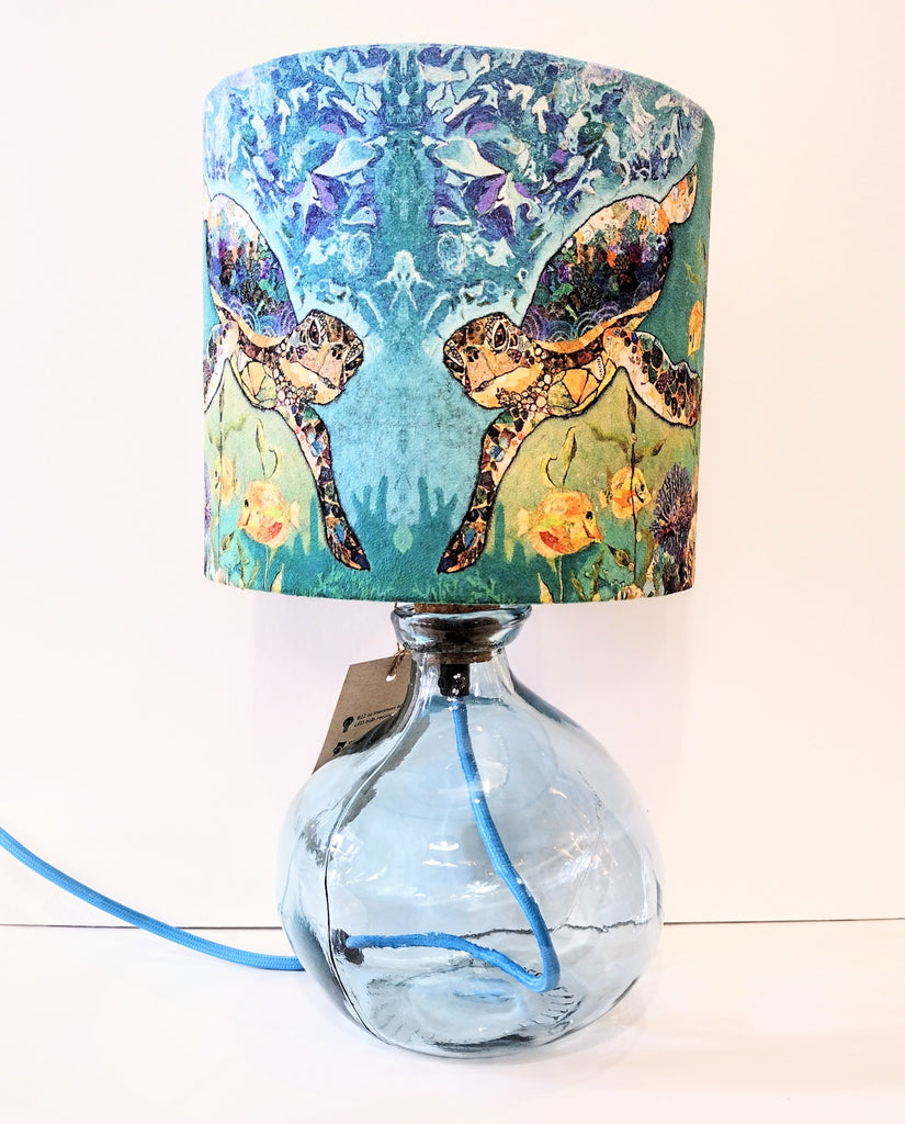 light blue recycled glass lamp-base shown with a turtles lampshade
