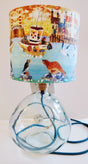 Pale grey recycled glass lamp-base shown with a coastal themed lampshade